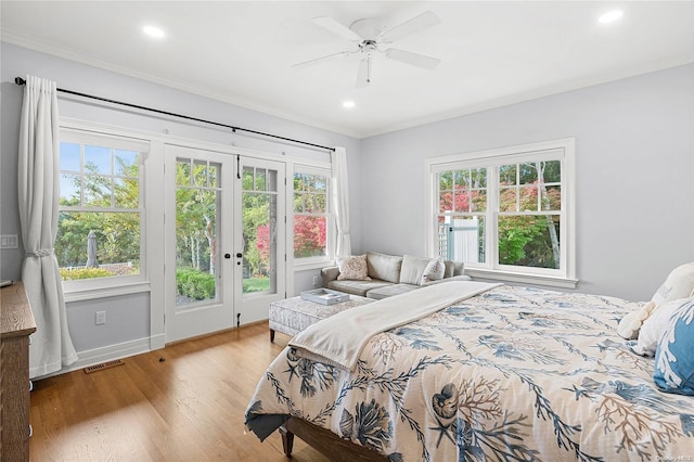 bedroom featuring access to exterior, light wood-type flooring, multiple windows, and ceiling fan