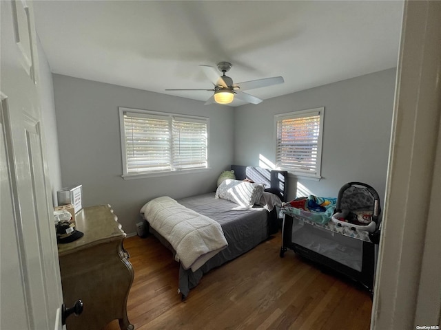 bedroom featuring ceiling fan and dark hardwood / wood-style flooring