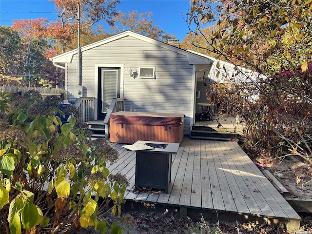 exterior space with a hot tub and a deck