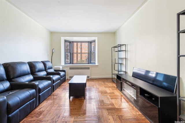 living room featuring light parquet floors and radiator