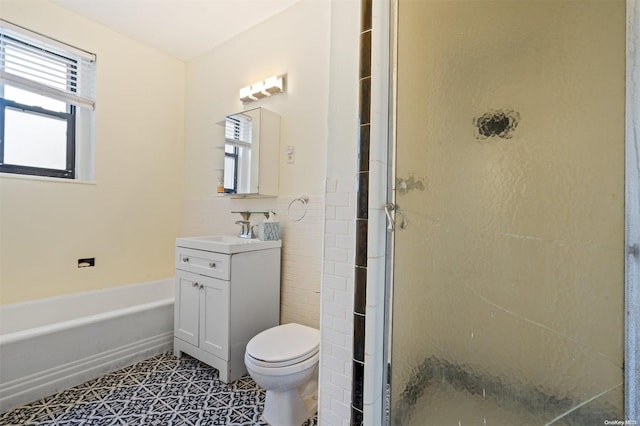 full bathroom with vanity, tile patterned flooring, toilet, tile walls, and independent shower and bath