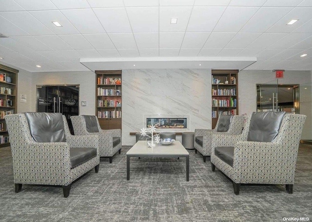 living room featuring built in features and dark carpet