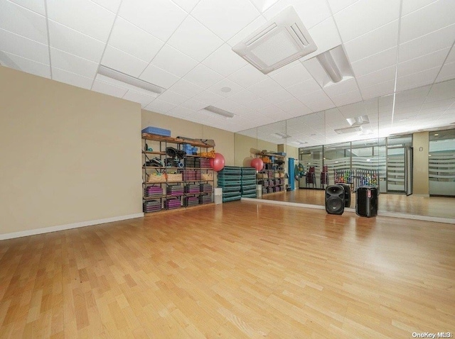 exercise room with wood-type flooring