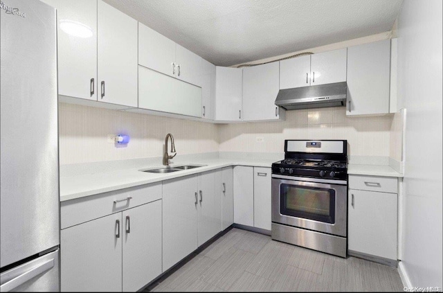 kitchen featuring white cabinetry, sink, a textured ceiling, and appliances with stainless steel finishes