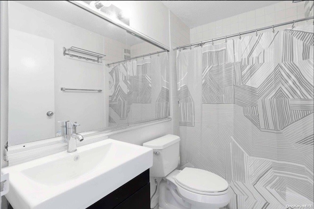 bathroom featuring a shower with curtain, vanity, and toilet