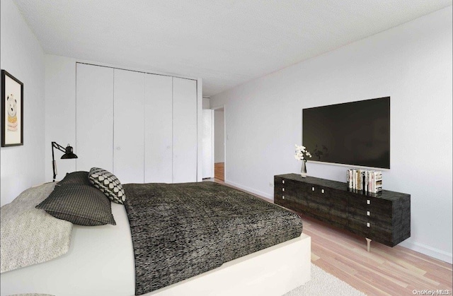 bedroom featuring a closet, wood-type flooring, and a textured ceiling