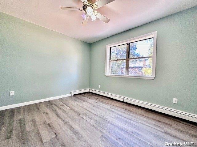 spare room featuring ceiling fan and light wood-type flooring