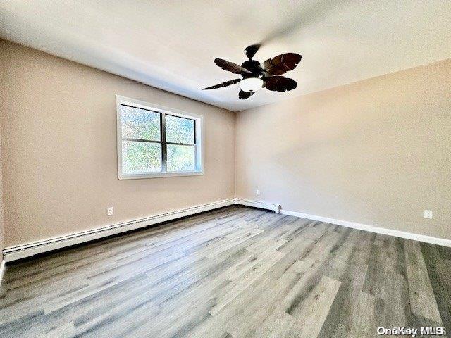 unfurnished room with light wood-type flooring and ceiling fan