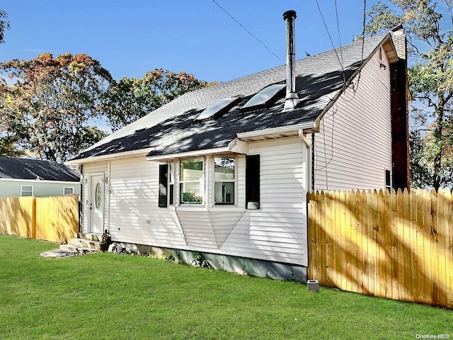 view of home's exterior featuring a lawn