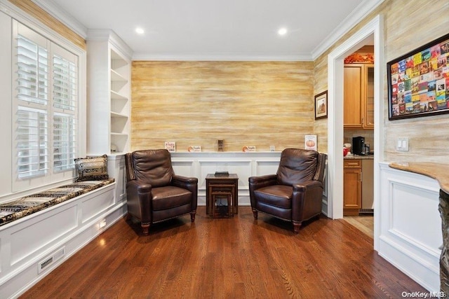 sitting room with dark hardwood / wood-style floors and crown molding