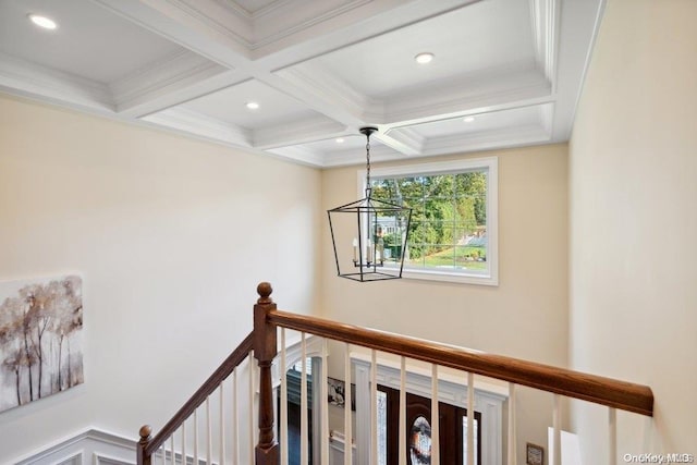 hallway featuring crown molding, beamed ceiling, coffered ceiling, and an inviting chandelier