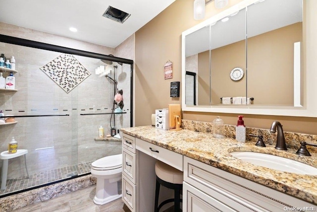 bathroom featuring vanity, toilet, an enclosed shower, and wood-type flooring