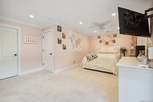 unfurnished bedroom with ceiling fan, light colored carpet, and crown molding