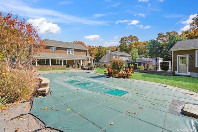 view of pool with a lawn and a patio area