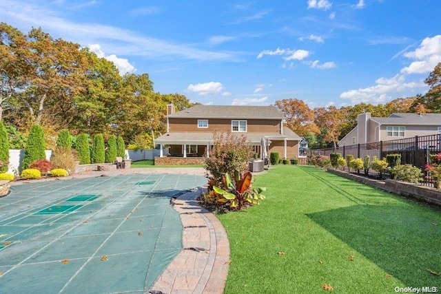 back of property featuring a lawn and cooling unit