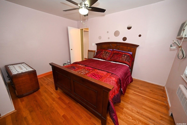 bedroom with ceiling fan and hardwood / wood-style floors