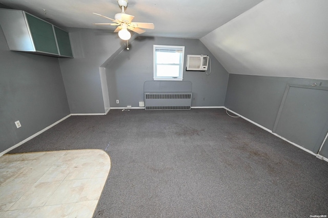 bonus room with ceiling fan, radiator heating unit, an AC wall unit, lofted ceiling, and carpet