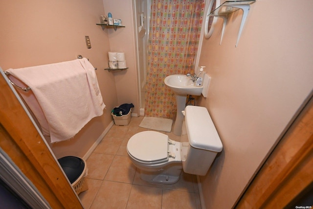 bathroom featuring tile patterned flooring, toilet, and a shower with shower curtain