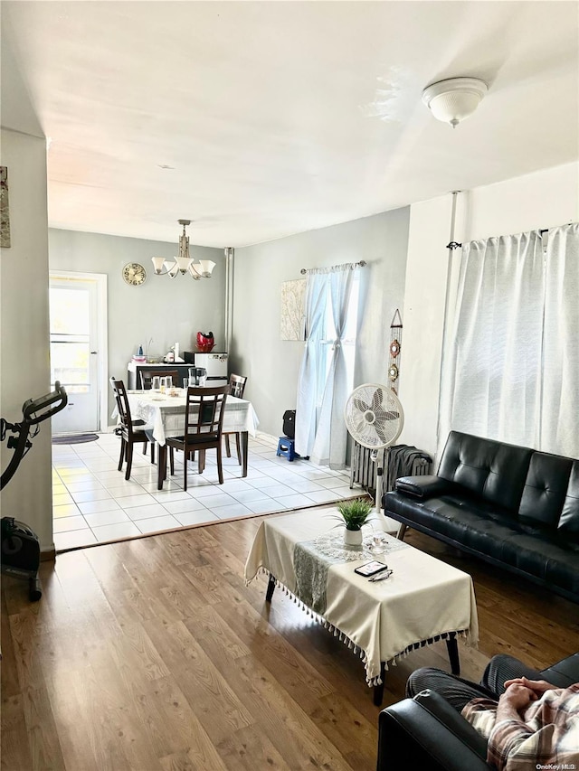 living room featuring an inviting chandelier and light hardwood / wood-style flooring