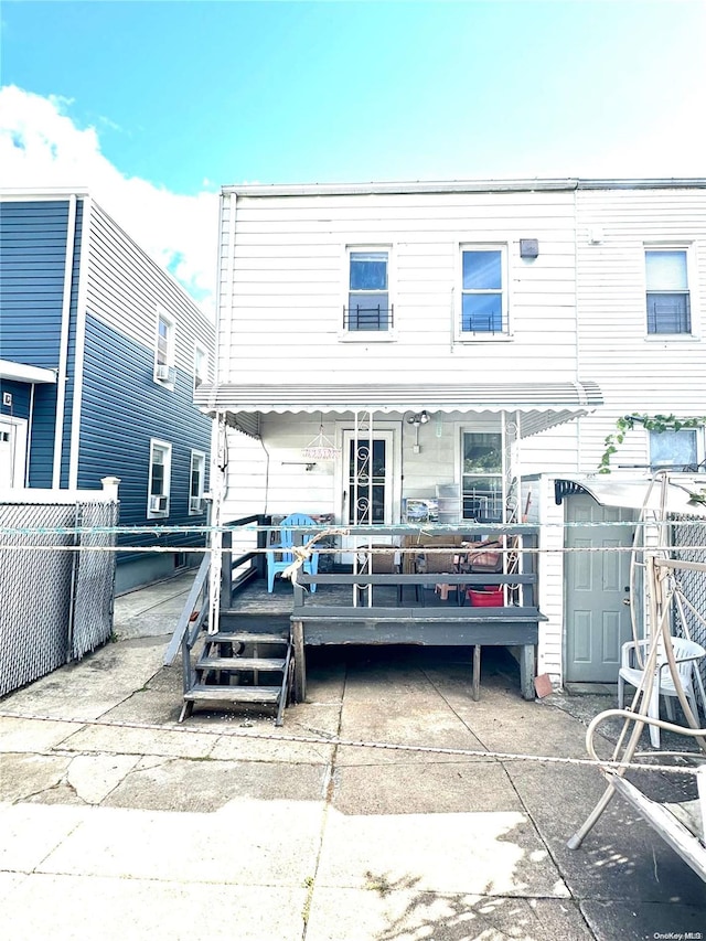 back of property featuring a wooden deck