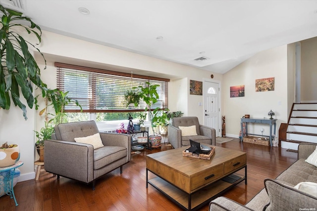 living room with dark hardwood / wood-style floors and lofted ceiling