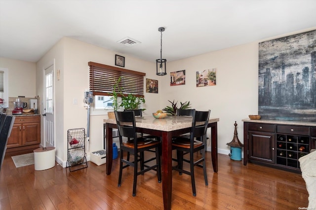 dining space with dark hardwood / wood-style floors