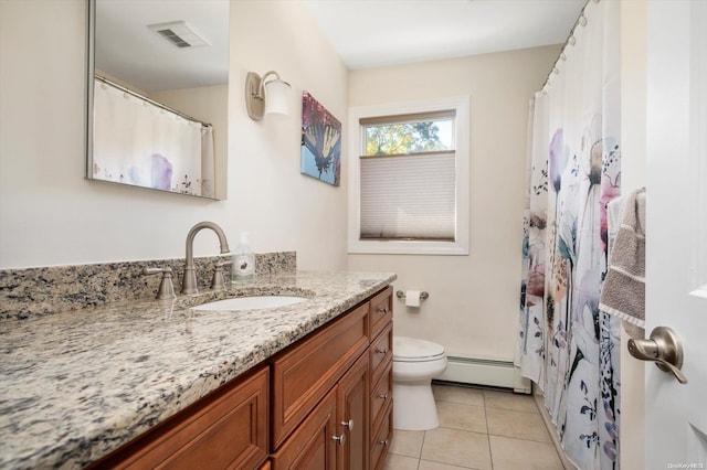 bathroom featuring tile patterned flooring, vanity, toilet, and baseboard heating