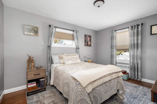 bedroom featuring hardwood / wood-style floors and multiple windows