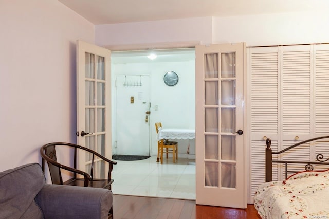 bedroom featuring hardwood / wood-style floors, french doors, and a closet