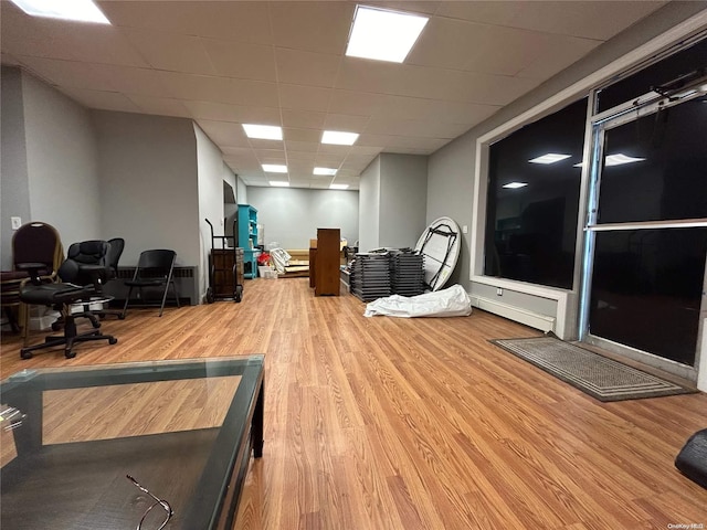 workout area featuring hardwood / wood-style flooring and a drop ceiling