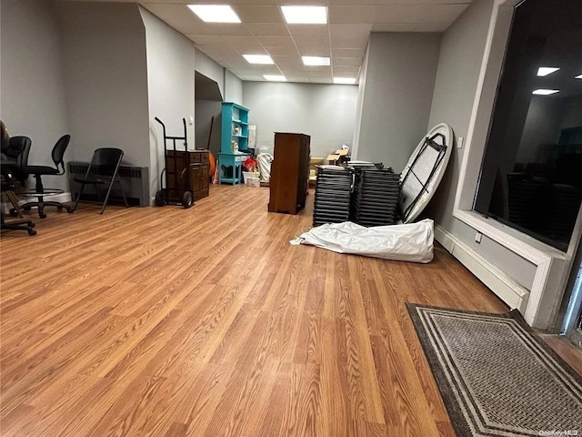 miscellaneous room with a paneled ceiling and light hardwood / wood-style floors