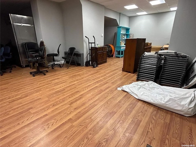 interior space with light hardwood / wood-style flooring and a drop ceiling