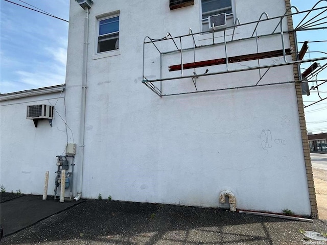 view of side of property featuring an AC wall unit