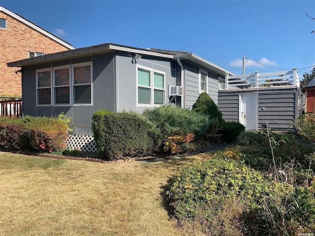 view of property exterior with a lawn