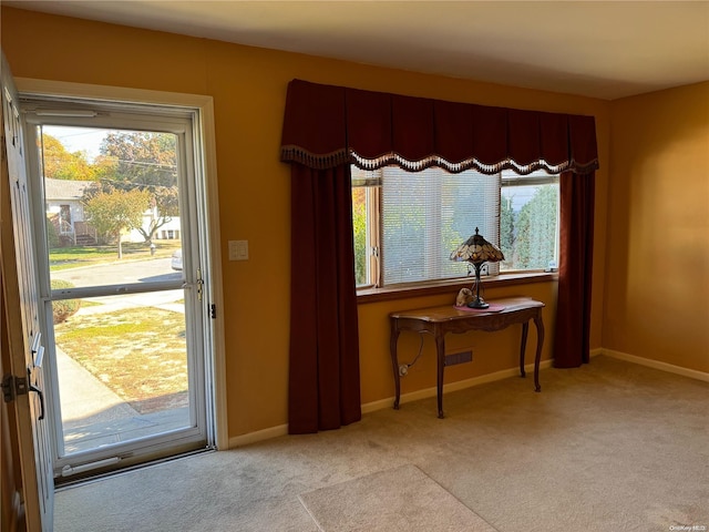 entryway featuring light carpet