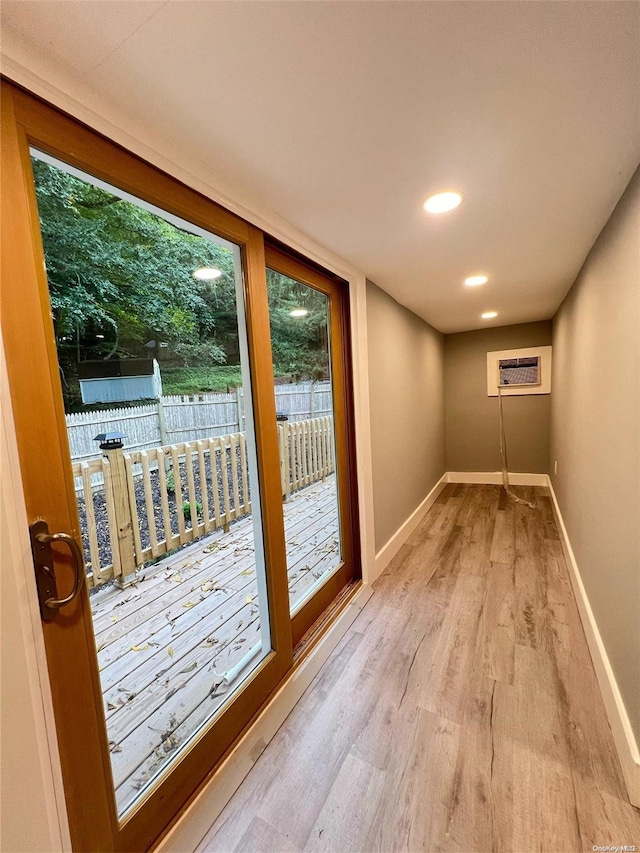 entryway with an AC wall unit and light hardwood / wood-style floors