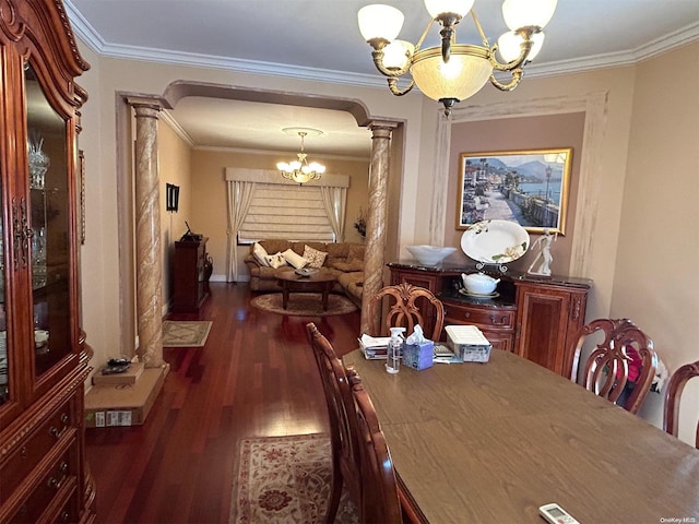 dining room featuring a chandelier, dark hardwood / wood-style flooring, crown molding, and decorative columns