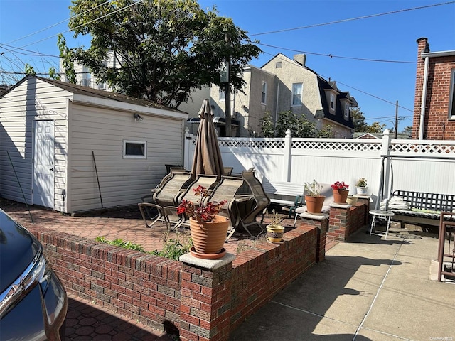 view of patio featuring a grill and an outdoor structure