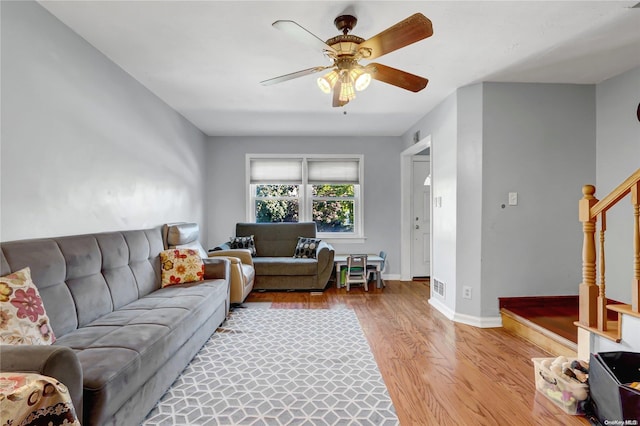 living room with ceiling fan and light hardwood / wood-style flooring