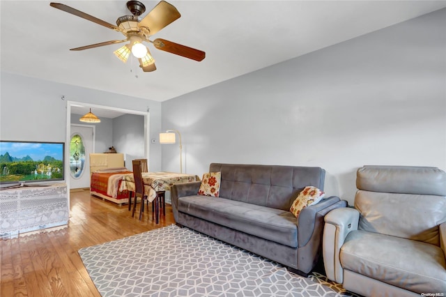 living room with hardwood / wood-style flooring and ceiling fan