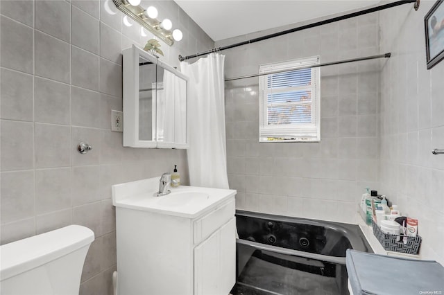 full bathroom with shower / bath combination with curtain, vanity, toilet, and tile walls