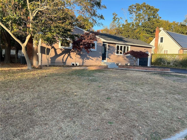 view of front of home featuring central AC and a front lawn