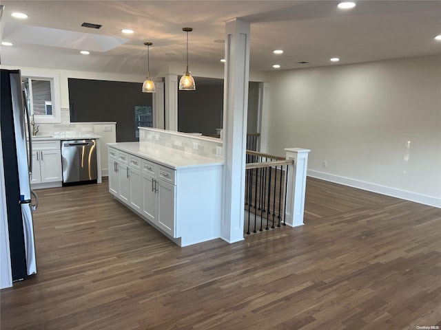 kitchen with tasteful backsplash, white cabinets, dark wood-type flooring, and appliances with stainless steel finishes