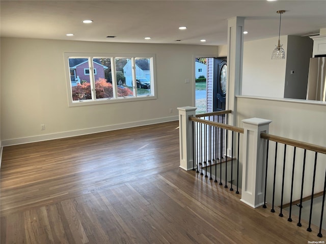 unfurnished room with dark hardwood / wood-style flooring