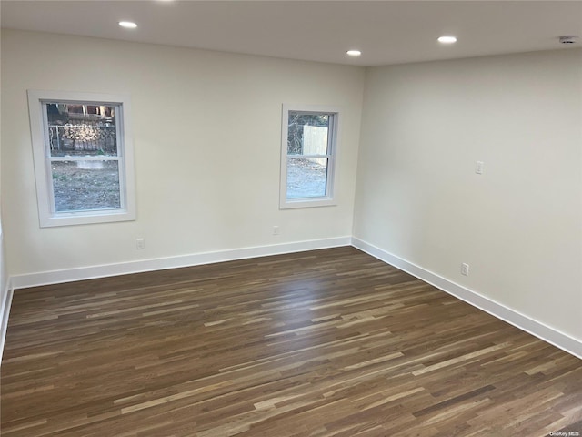 empty room featuring dark hardwood / wood-style flooring