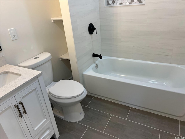 full bathroom featuring tile patterned floors, tiled shower / bath, vanity, and toilet