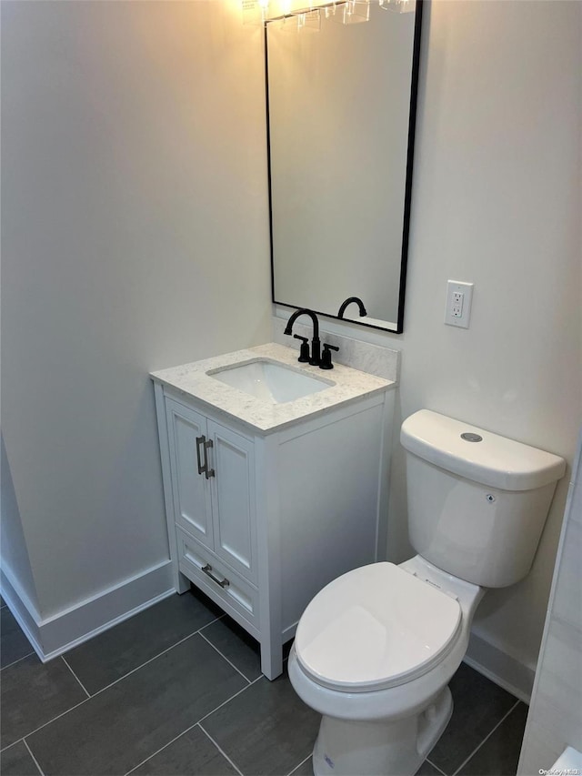 bathroom with tile patterned floors, vanity, and toilet