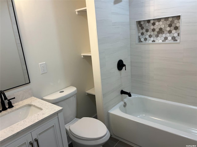 full bathroom featuring tile patterned flooring, vanity, tiled shower / bath combo, and toilet