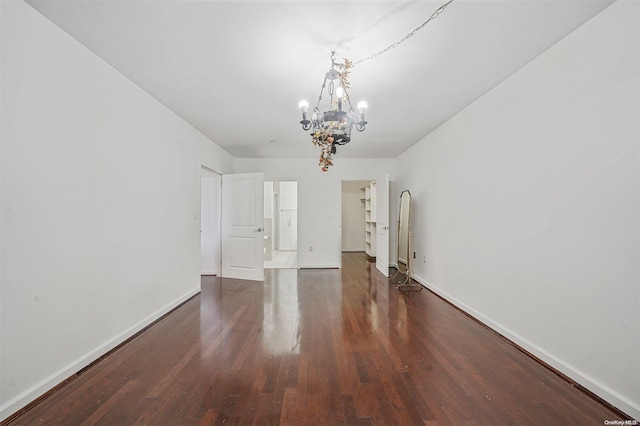 interior space featuring a chandelier and dark wood-type flooring