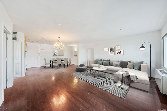 living room with dark wood-type flooring and a chandelier